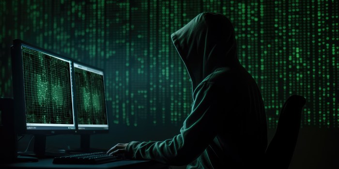 un hacker lavora al computer in un ambiente cupo e pieno di righe di codice
